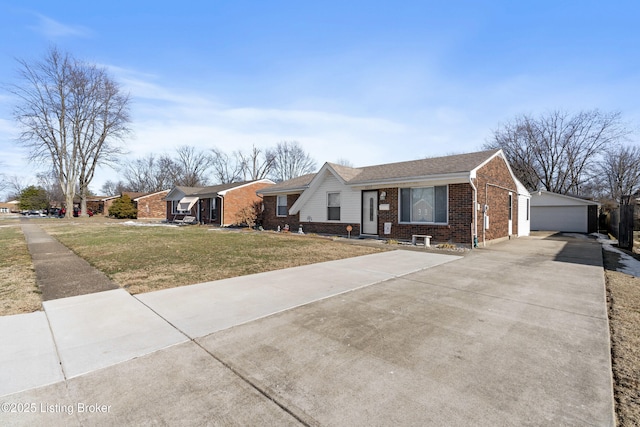 single story home featuring a garage, an outdoor structure, and a front lawn