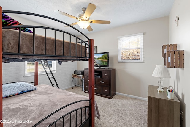 carpeted bedroom with a textured ceiling and ceiling fan