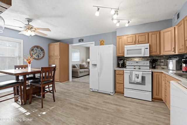 kitchen with white appliances, ceiling fan, tasteful backsplash, a textured ceiling, and light wood-type flooring