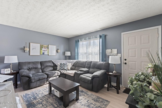 living room featuring a textured ceiling and light wood-type flooring