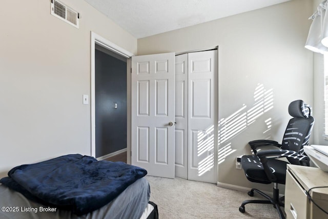 carpeted bedroom featuring a closet