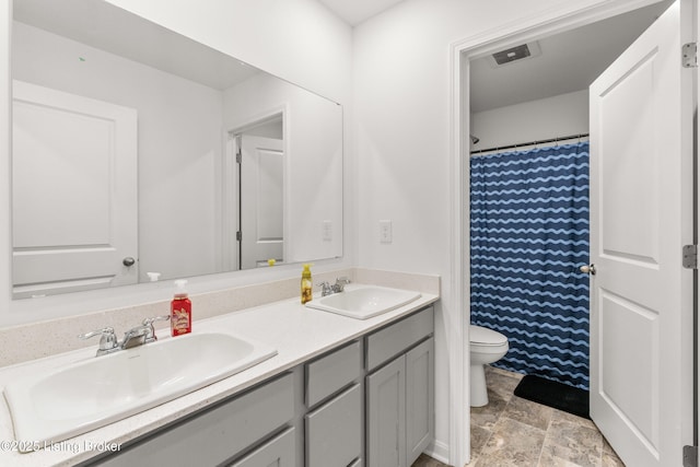 bathroom featuring vanity, toilet, and walk in shower