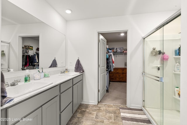 bathroom featuring vanity and a shower with shower door