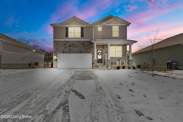 view of property with a garage and covered porch