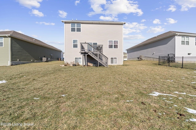 back of property with cooling unit, a yard, and a deck