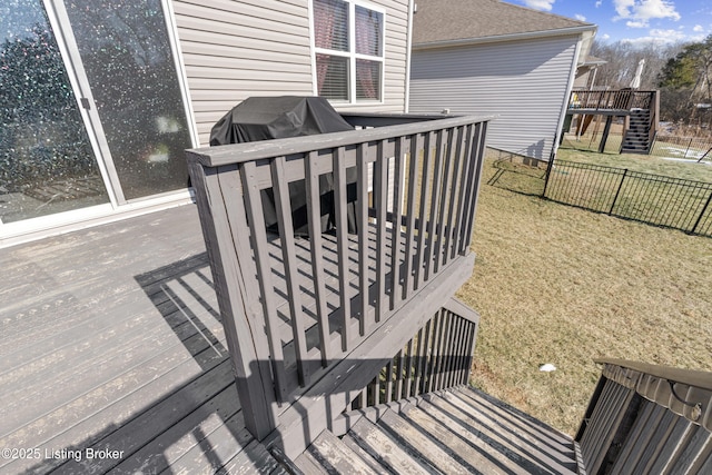 wooden terrace featuring a lawn