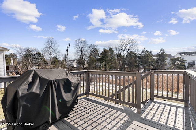 wooden deck featuring a grill