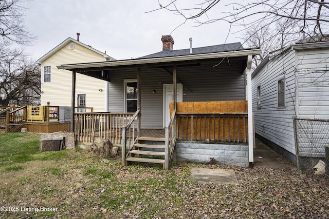 rear view of property featuring a deck