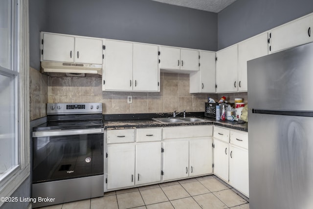 kitchen featuring white cabinetry, stainless steel appliances, sink, and light tile patterned floors