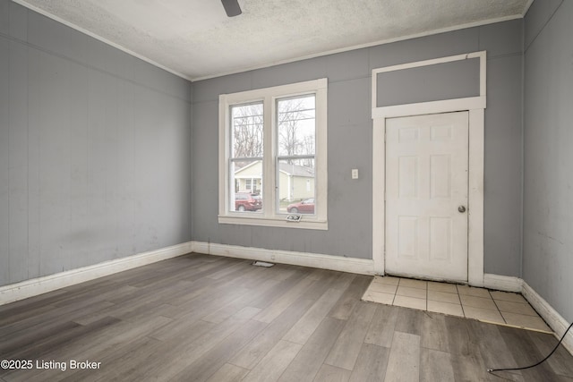 foyer entrance featuring hardwood / wood-style flooring, a textured ceiling, and ceiling fan