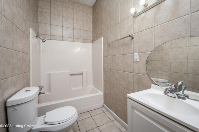 full bathroom with shower / tub combination, tile walls, tile patterned flooring, vanity, and toilet