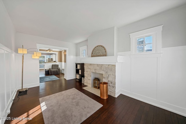 living room featuring hardwood / wood-style flooring and a stone fireplace