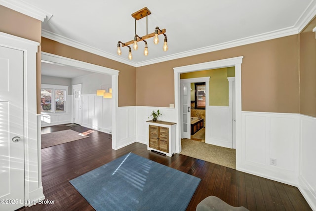 dining area with crown molding, a chandelier, and dark hardwood / wood-style flooring