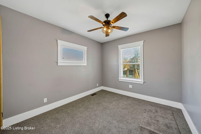 carpeted spare room with ceiling fan