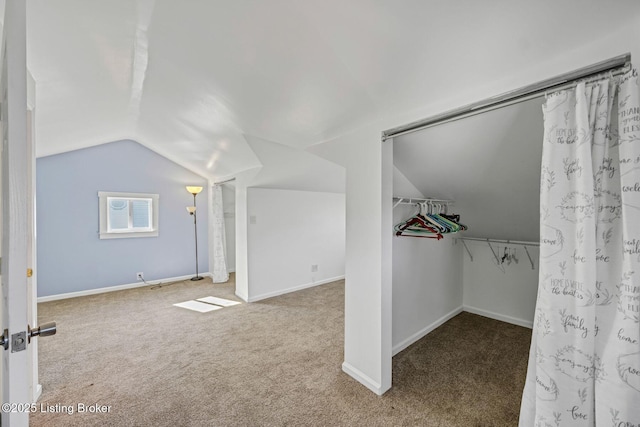 interior space featuring lofted ceiling and carpet floors