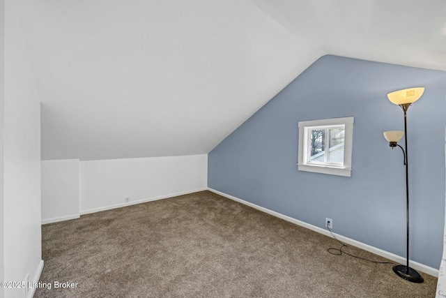 bonus room with carpet flooring and vaulted ceiling