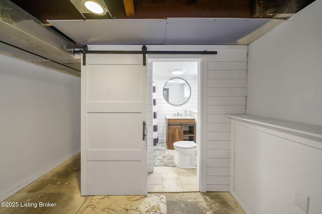 bathroom featuring toilet, concrete flooring, and sink