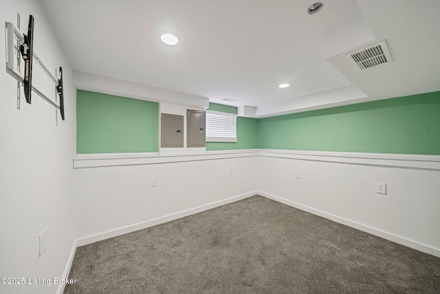 carpeted spare room featuring electric panel