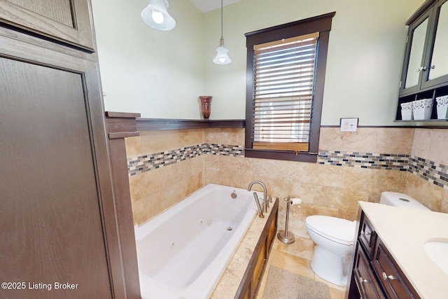 bathroom featuring toilet, tile walls, vanity, a relaxing tiled tub, and tile patterned flooring