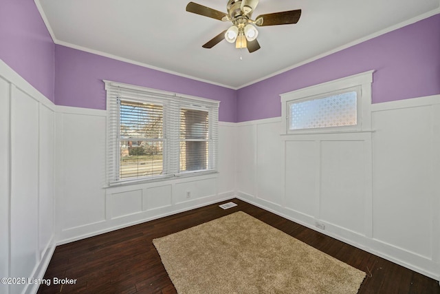 unfurnished room with dark wood-type flooring, ornamental molding, and ceiling fan