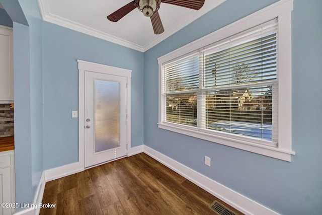 interior space featuring ceiling fan, ornamental molding, and dark hardwood / wood-style floors