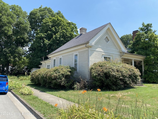 view of property exterior featuring a lawn