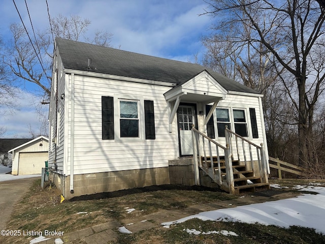 view of front of property featuring a garage and an outbuilding