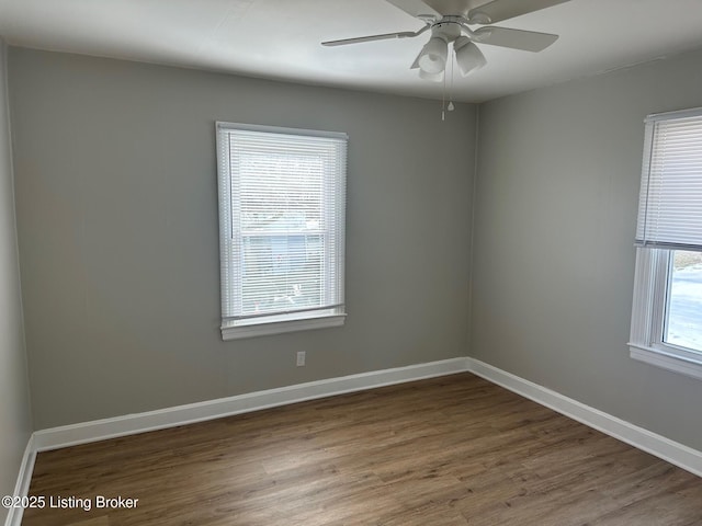 unfurnished room featuring dark hardwood / wood-style floors and ceiling fan