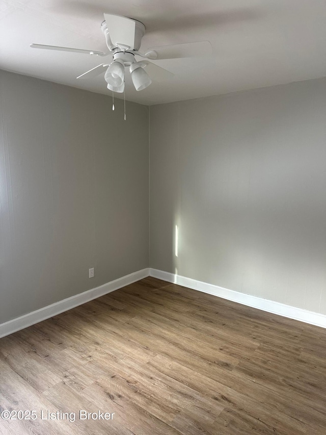 unfurnished room with hardwood / wood-style flooring and ceiling fan