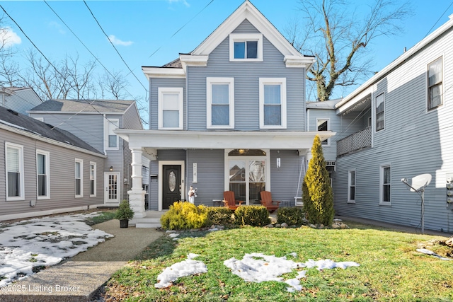 view of front of house with a porch and a front yard