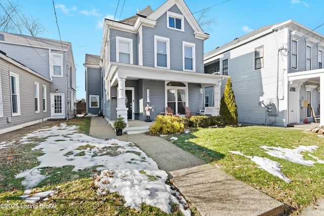 view of front of property with a front yard and a porch