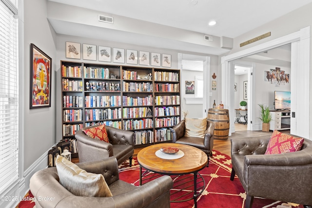 living area with hardwood / wood-style flooring