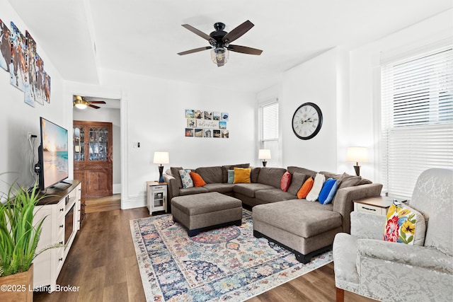 living room with dark hardwood / wood-style flooring and ceiling fan