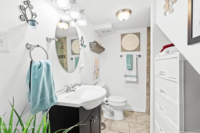 bathroom featuring vanity, tile patterned floors, and toilet