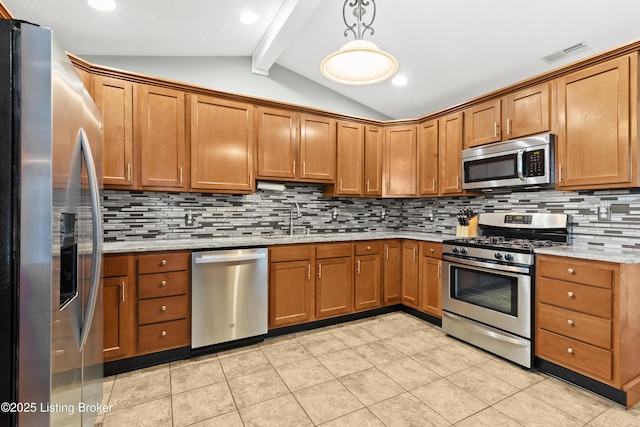 kitchen featuring sink, decorative light fixtures, lofted ceiling with beams, appliances with stainless steel finishes, and light stone countertops