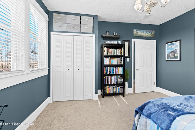 bedroom with a closet, carpet flooring, and a textured ceiling