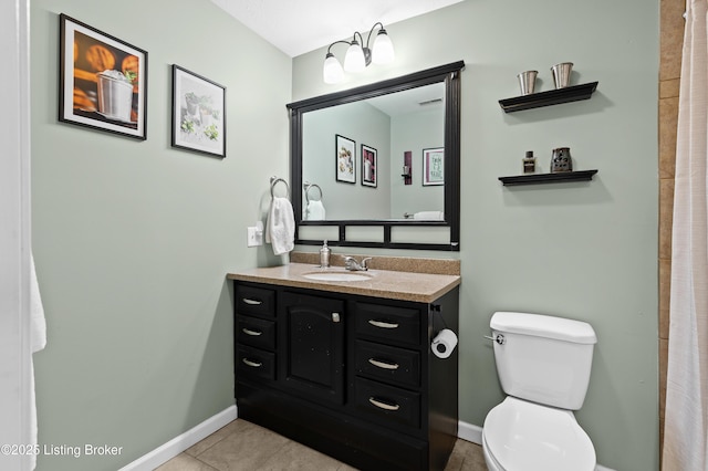 bathroom with vanity, tile patterned floors, and toilet