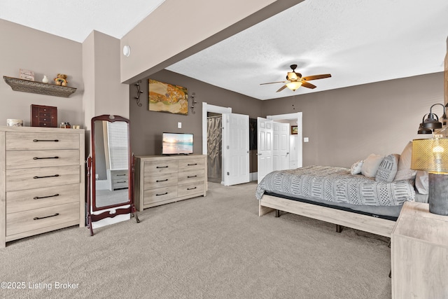 carpeted bedroom with a textured ceiling and ceiling fan