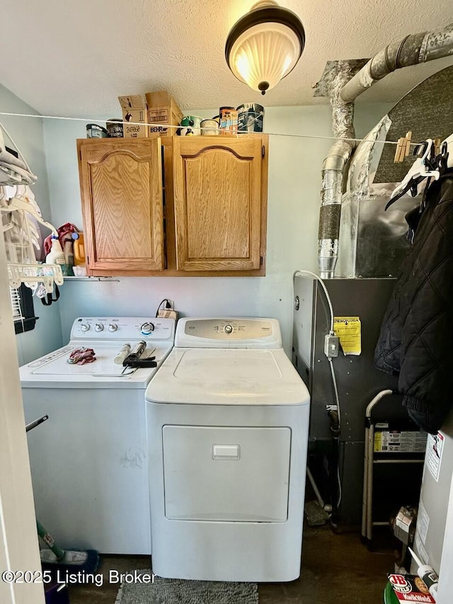 washroom with washing machine and dryer and cabinets