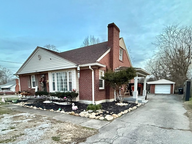 view of front of home with a garage and an outdoor structure