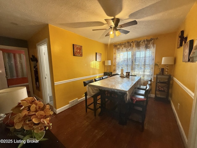 dining space featuring ceiling fan, a textured ceiling, and dark hardwood / wood-style flooring