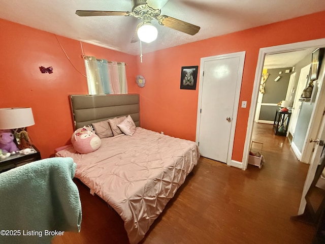 bedroom featuring dark hardwood / wood-style flooring and ceiling fan