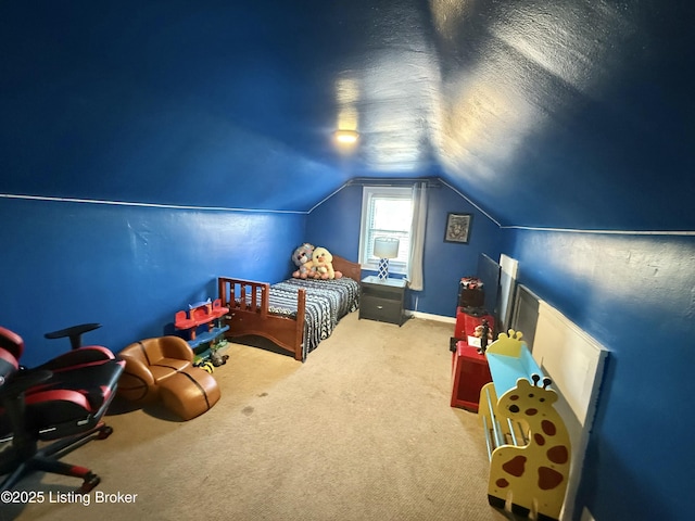 carpeted bedroom featuring vaulted ceiling