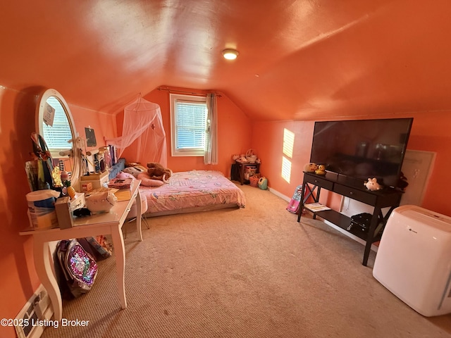 carpeted bedroom with lofted ceiling