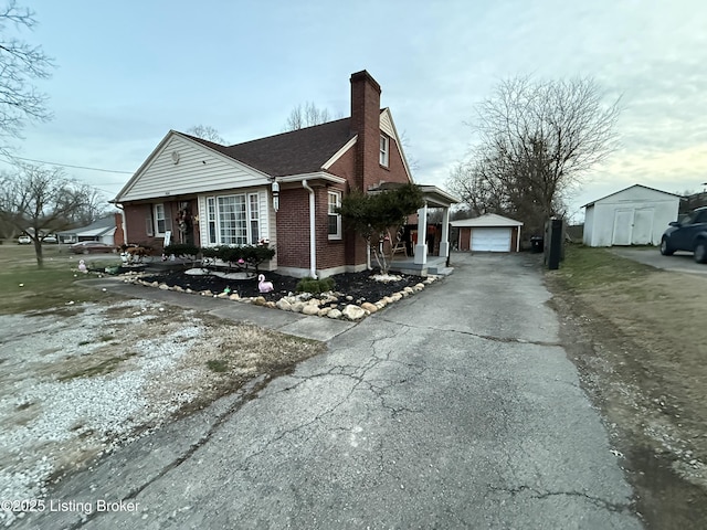 view of home's exterior with a garage and a shed