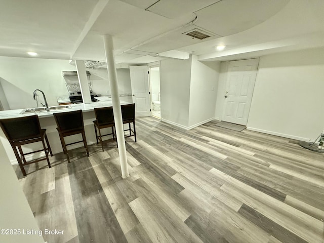 bar featuring sink and hardwood / wood-style flooring