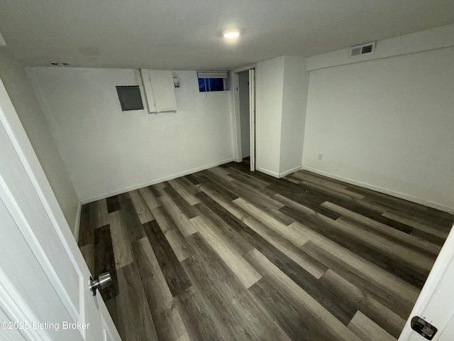 basement featuring dark hardwood / wood-style flooring