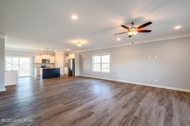 unfurnished living room featuring dark wood-type flooring, ornamental molding, and ceiling fan