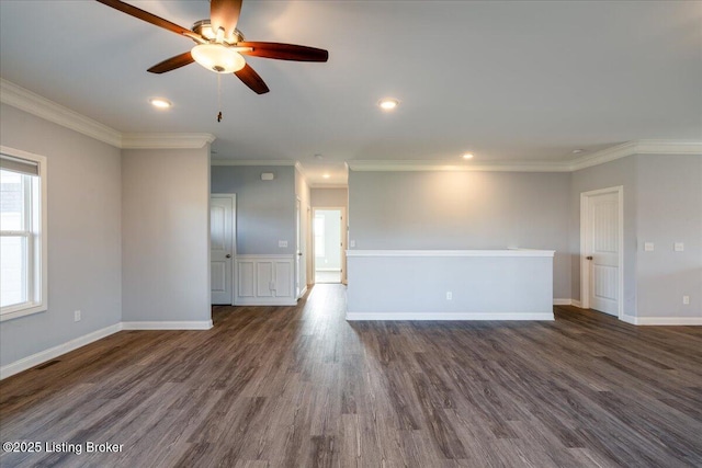 empty room featuring dark hardwood / wood-style flooring, crown molding, and ceiling fan