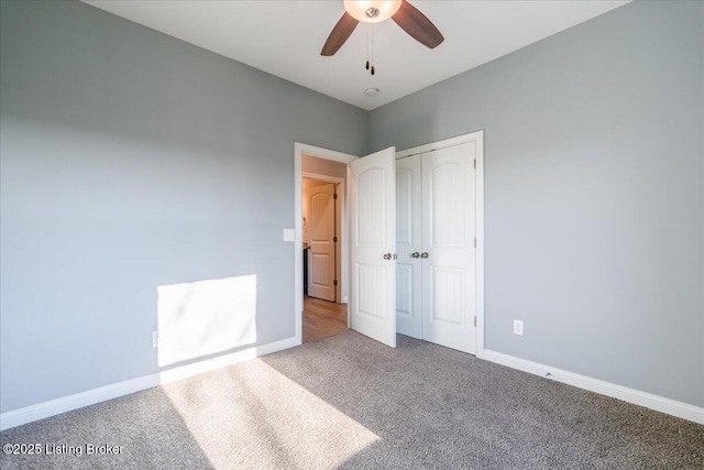 unfurnished bedroom featuring carpet flooring, ceiling fan, and a closet